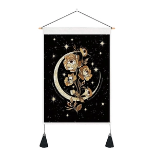 Detail of celestial moon tapestry with gold star patterns and black tassels on wood bar
