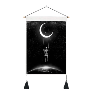 Detail of skull on crescent moon tapestry with wooden rod and black tassels decoration