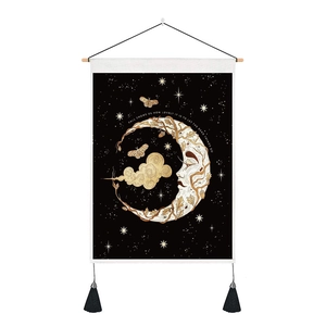 Detail of celestial moon and stars tapestry with wooden rod and black tassels