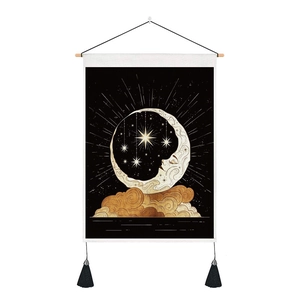 Macro detail of sun and moon wall tapestry featuring elegant black tassels and wood rod