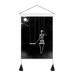 Detail of skull on swing tapestry featuring black tassels and a wooden hanging rod
