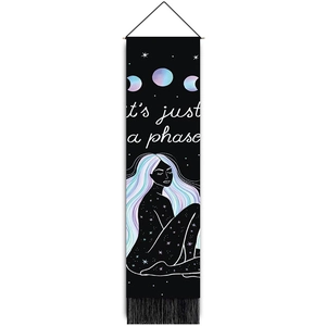 Vertical black wall tapestry with moon phases, tassels, and 'it's just a phase' text