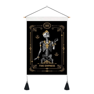 Detail view of The Empress tarot wall hanging with skull design, wooden bar and black tassels