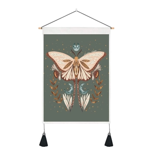 Bohemian Luna Moth wall tapestry with moon phases and fringe on a wooden hanging pole