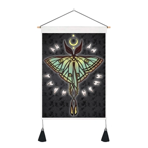 Detail of lunar moth tapestry showing green wings and phases of the moon on grey canvas