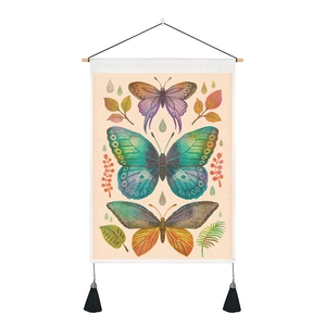 Detail of vintage butterfly wall tapestry featuring wooden rod and black tassel accents