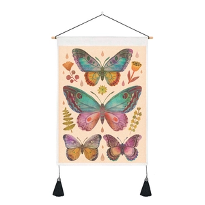 Detail of vintage butterfly tapestry with wooden hanging rod and black tassels