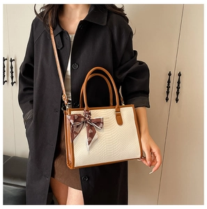 Detail of contrast embossed tote bag with printed silk scarf and adjustable strap