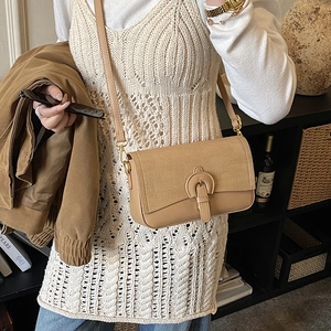 Vintage patchwork crossbody bag in khaki leather and woven texture shown on model