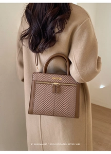Model view of a brown retro handbag with herringbone pattern and gold JINGPIN logo detail