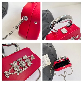 Detailed views of red rhinestone evening bag with heart handle and silver chain