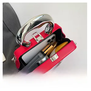 Interior view showing the capacity of a red box bag with a silver handle and chain strap