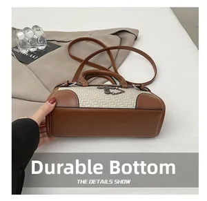 Detail view of the wear-resistant bottom on the woven cross shoulder bag for women