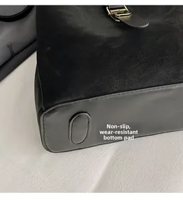 Detail of the black bucket bag bottom with protective pads and non-slip wear-resistant base