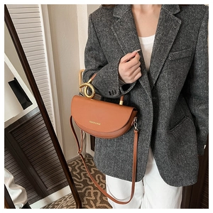 Brown semi-circular leather crossbody bag with gold metal handle and logo detail