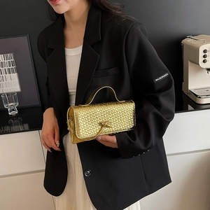 Metallic gold woven bag with knot detail and top handle for trendy evening fashion