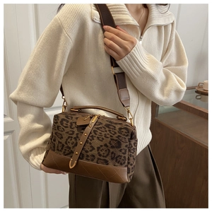 Detail of leopard print crossbody bag with diamond quilted leather and top handle