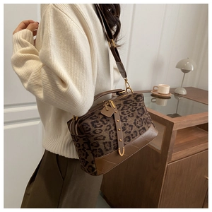 Detail of leopard print suede crossbody bag with gold hardware and quilting