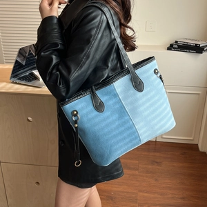 Large capacity denim tote bag with patchwork blue fabric and black leather handles