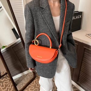 Fashionable orange saddle bag with golden metal ring and detachable shoulder strap