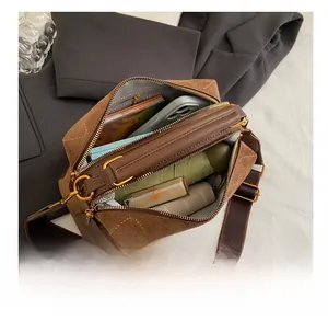 Top view of brown suede satchel showing spacious interior with daily essentials