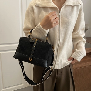 Quilted black suede pillow bag with gold rivet buckle and stylish wide shoulder strap