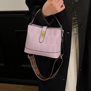 Chic lavender bucket bag with weave texture and jacquard strap shown in lifestyle context