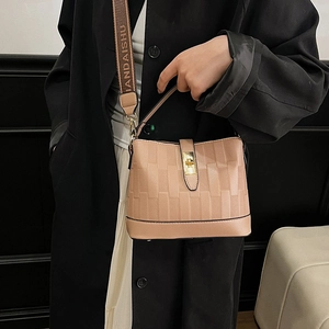 Beige bucket bag with textured check pattern and wide lettered strap for women