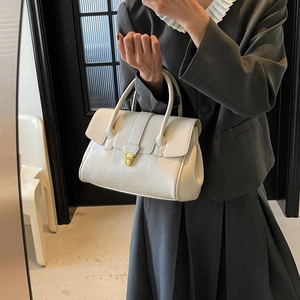 Minimalist beige leather tote bag with elegant gold twist lock and dual top handles