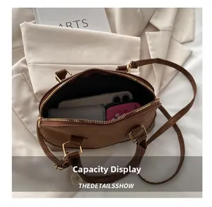 Detailed capacity display showing interior space for phone and wallet in leopard shell bag