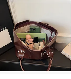 Large brown leather tote bag interior showing spacious capacity for tablet and cosmetics