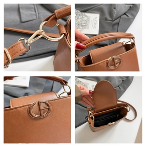 Close-up of caramel lychee leather textures, golden hardware, and spacious inner lining