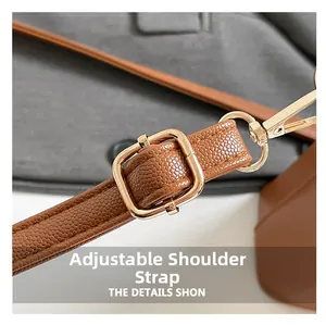 Detail of adjustable brown lychee texture leather strap with gold buckle and lobster clasp