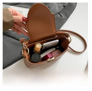 Top-down view of brown bucket bag showing large capacity for phone and cosmetics