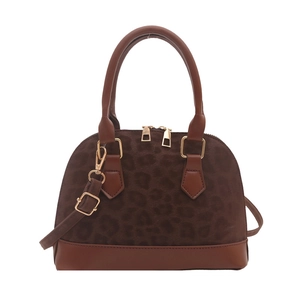 Fashionable leopard print dome handbag with brown leather trim and golden hardware