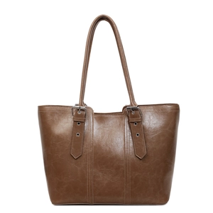 Large brown vintage leather tote bag with vertical stitching and adjustable handles