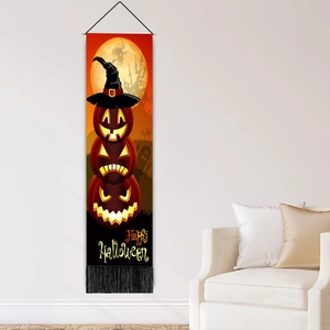Vertical Halloween hanging flag with pumpkins and witch on a white wall in a cozy room