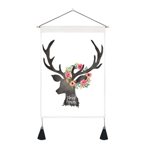 Nordic style hanging tapestry with floral reindeer silhouette and black tassels