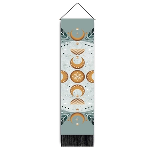Detail view of bohemian wall tapestry with moon phases and black decorative tassels
