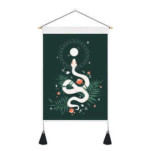 Detail of bohemian tapestry featuring white snake and pink flowers with black tassels