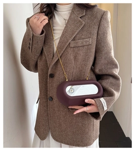 Mirror-detail burgundy frosted crossbody bag with a sleek gold chain and oval shape