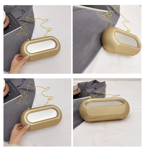 Detail of gold capsule evening bag with mirror inlay and fine chain strap detail