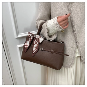 Detail of lychee pattern leather tote bag with vintage silk scarf and buckle accent