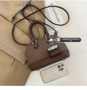 Brown shell bag with herringbone fabric and iPhone 12 Pro shown for size comparison