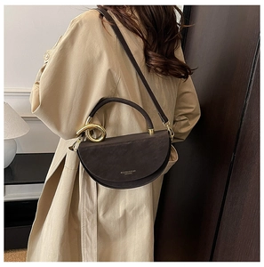 Side view of dark brown crescent bag featuring elegant golden twist metal hardware