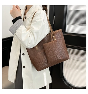 Detailed close-up of brown woven texture tote bag and matching smaller pouch set