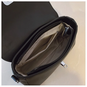 Internal view of messenger bag with multiple compartments and beige V-pattern lining