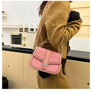 Pink patchwork crossbody bag with woven texture and silver metal buckle shown on model