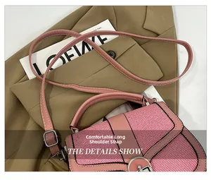 Detailed close-up of pink patchwork crossbody bag with adjustable long shoulder strap