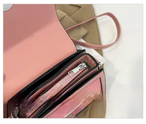 Internal view of pink PU leather crossbody bag showing dual compartments and smooth silver zipper